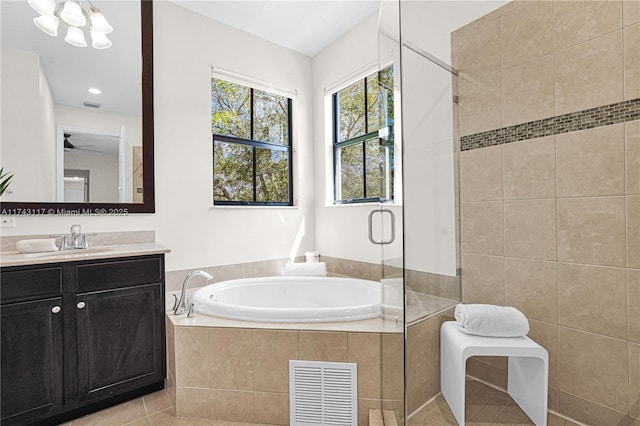 bathroom featuring tile patterned floors, shower with separate bathtub, and vanity