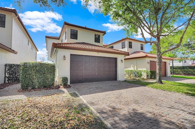 mediterranean / spanish home with a garage