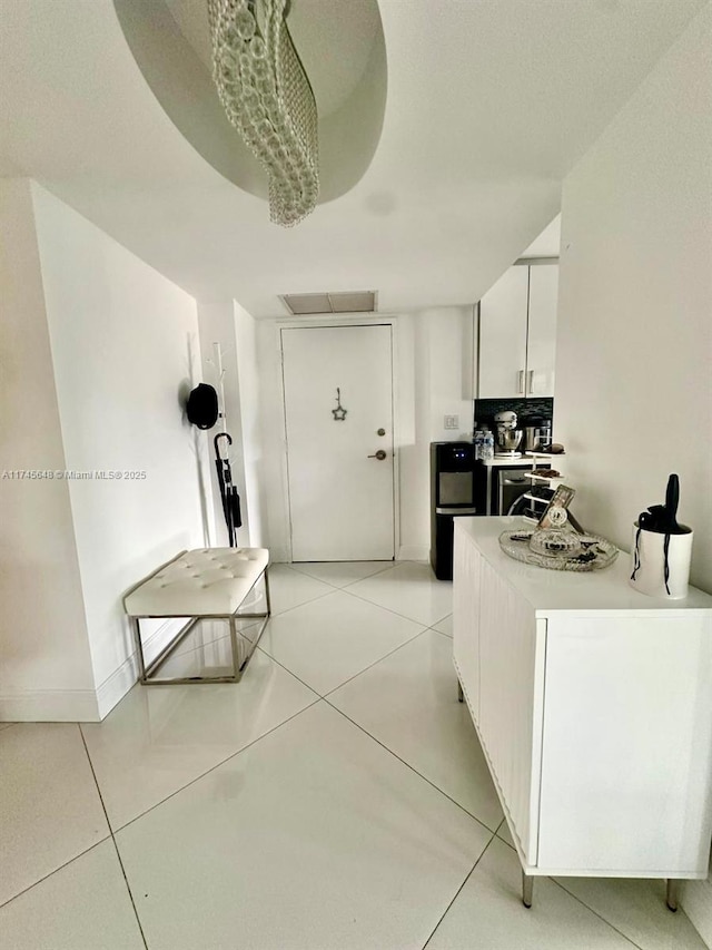 kitchen featuring light tile patterned flooring and white cabinets