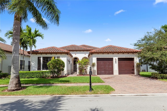 mediterranean / spanish home with a garage and a front yard