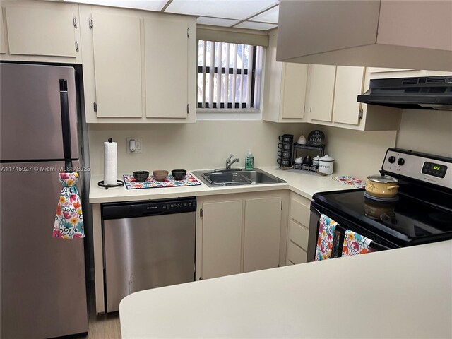 8290 Lake Dr Unit 223, Doral, FL 33166 - kitchen featuring light countertops, stainless steel appliances, under cabinet range hood, a sink, and wall chimney range hood