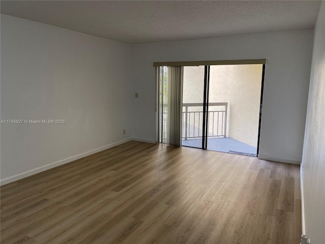 8290 Lake Dr Unit 223, Doral, FL 33166 - empty room featuring baseboards, wood finished floors, and a textured ceiling