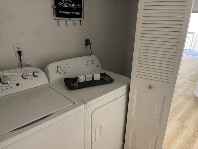 8290 Lake Dr Unit 223, Doral, FL 33166 - washroom featuring washing machine and dryer, wood finished floors, and laundry area