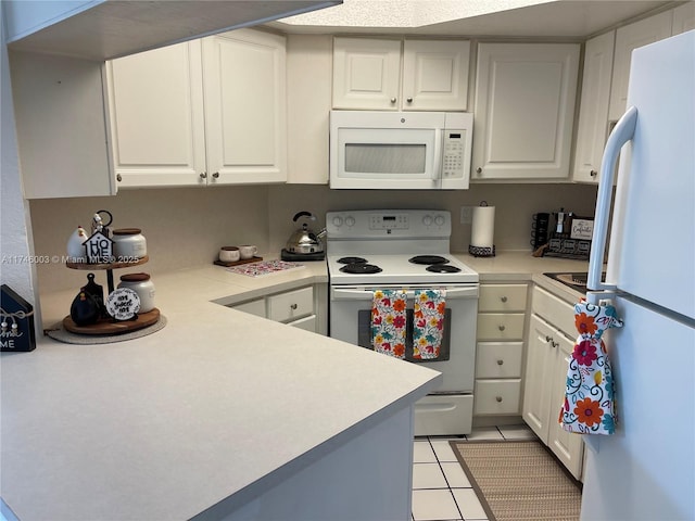 8225 Lake Dr Unit 502, Doral, FL 33166 - kitchen with white cabinets, light countertops, light tile patterned flooring, and white appliances