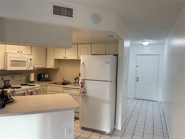 8225 Lake Dr Unit 502, Doral, FL 33166 - kitchen with a sink, light tile patterned floors, white appliances, visible vents, and white cabinets
