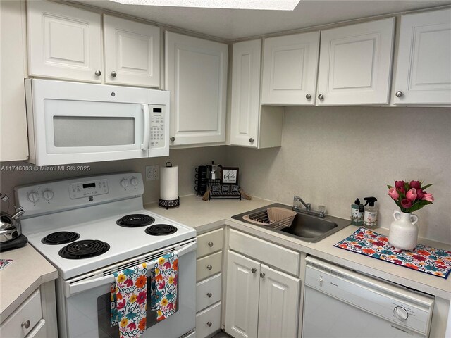 8225 Lake Dr Unit 502, Doral, FL 33166 - kitchen with white cabinetry, light countertops, a sink, and white appliances