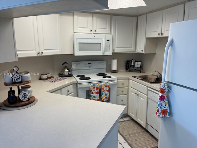 8225 Lake Dr Unit 502, Doral, FL 33166 - kitchen with white cabinetry, light countertops, a sink, and white appliances