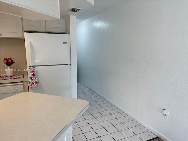8225 Lake Dr Unit 502, Doral, FL 33166 - kitchen with light countertops, visible vents, white appliances, baseboards, and light tile patterned floors