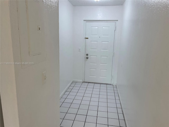 8225 Lake Dr Unit 502, Doral, FL 33166 - doorway featuring light tile patterned flooring, a textured ceiling, and baseboards