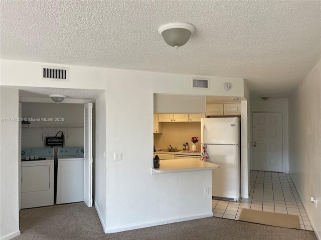 8225 Lake Dr Unit 502, Doral, FL 33166 - kitchen with freestanding refrigerator, light countertops, separate washer and dryer, and visible vents