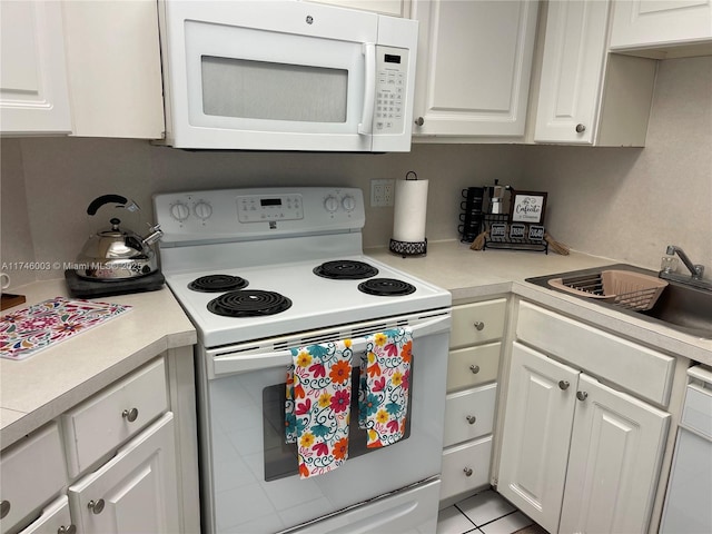 8225 Lake Dr Unit 502, Doral, FL 33166 - kitchen with light countertops, a sink, white cabinets, and white appliances
