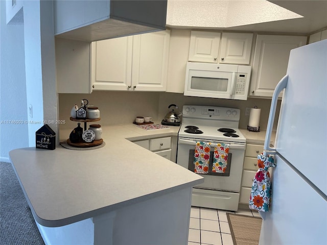 8225 Lake Dr Unit 502, Doral, FL 33166 - kitchen featuring white appliances, light countertops, light tile patterned floors, and a peninsula