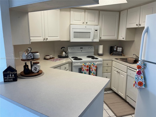 8225 Lake Dr Unit 502, Doral, FL 33166 - kitchen with white cabinets, light countertops, a sink, and white appliances