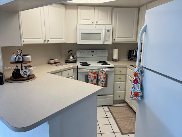 8225 Lake Dr Unit 502, Doral, FL 33166 - kitchen with light countertops, white appliances, light tile patterned floors, white cabinets, and a peninsula