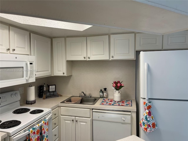 8225 Lake Dr Unit 502, Doral, FL 33166 - kitchen featuring white cabinets, a sink, light countertops, and white appliances