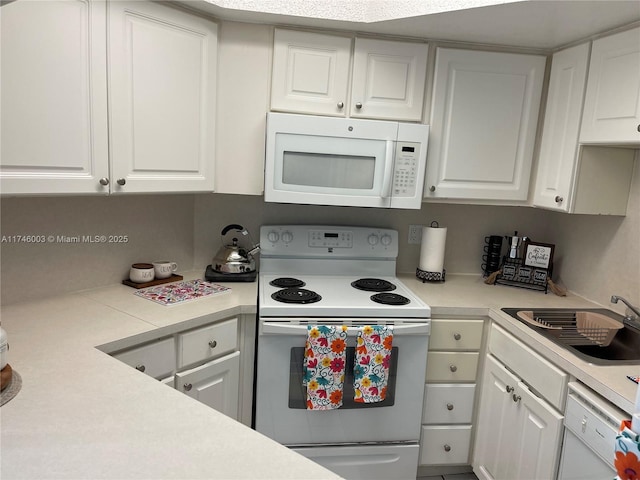 8225 Lake Dr Unit 502, Doral, FL 33166 - kitchen with white cabinets, a sink, light countertops, and white appliances