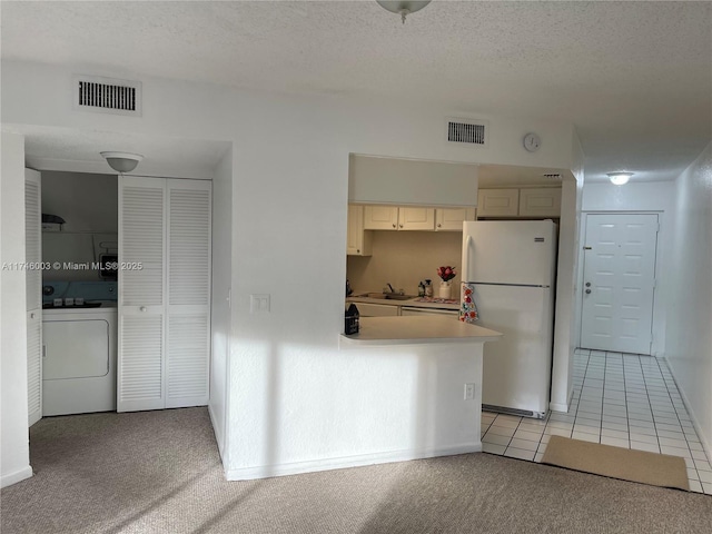 8225 Lake Dr Unit 502, Doral, FL 33166 - kitchen with a textured ceiling, visible vents, washer / dryer, and freestanding refrigerator