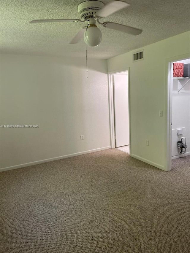 8225 Lake Dr Unit 502, Doral, FL 33166 - empty room featuring carpet flooring, a textured ceiling, visible vents, baseboards, and ceiling fan