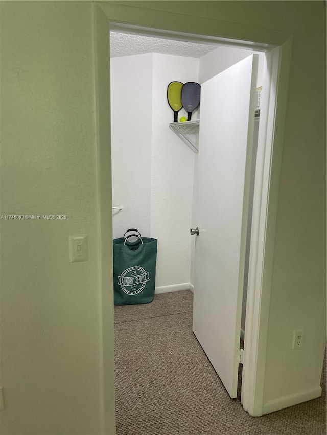 8225 Lake Dr Unit 502, Doral, FL 33166 - hall featuring baseboards, carpet, and a textured ceiling