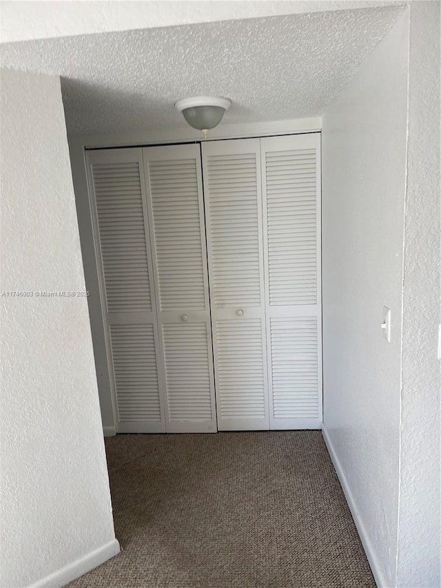 8225 Lake Dr Unit 502, Doral, FL 33166 - interior space featuring a closet, carpet floors, a textured wall, and a textured ceiling