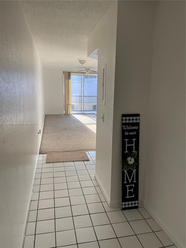 8225 Lake Dr Unit 502, Doral, FL 33166 - corridor with light tile patterned flooring, a textured ceiling, a textured wall, and light colored carpet