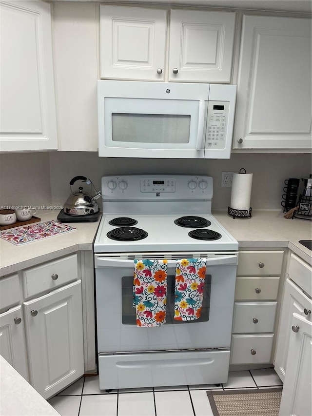 8225 Lake Dr Unit 502, Doral, FL 33166 - kitchen with white cabinetry, light countertops, and white appliances