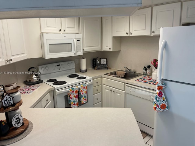 8225 Lake Dr Unit 502, Doral, FL 33166 - kitchen with white appliances, white cabinetry, light countertops, and a sink