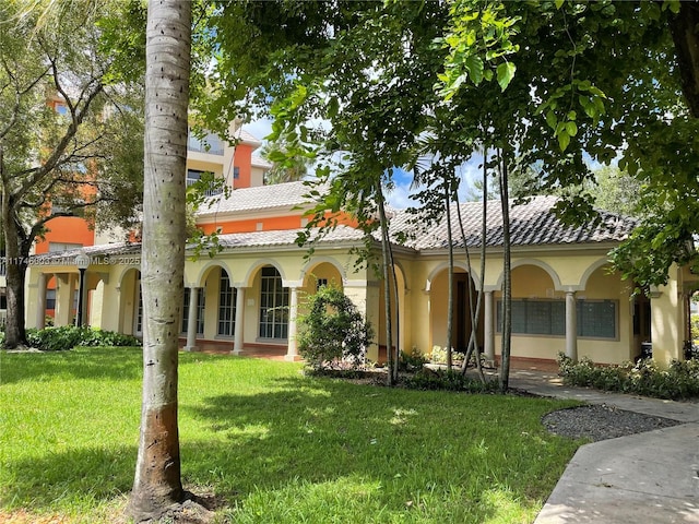 8225 Lake Dr Unit 502, Doral, FL 33166 - mediterranean / spanish-style home featuring a tiled roof, stucco siding, and a front lawn