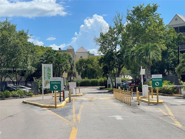 8225 Lake Dr Unit 502, Doral, FL 33166 - view of street with a speed bump, traffic signs, and a gated entry