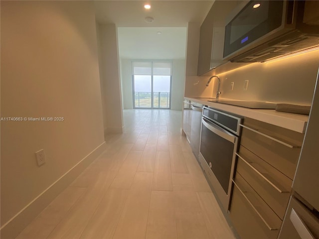 kitchen featuring tasteful backsplash, stainless steel appliances, and sink