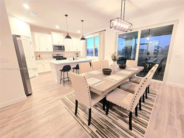 dining space with light hardwood / wood-style flooring