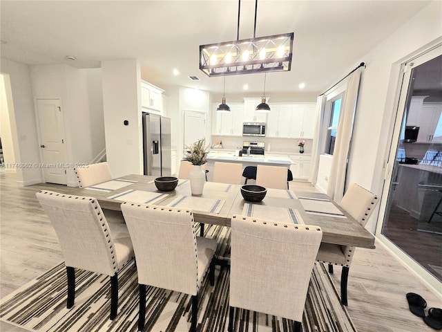 dining area featuring light wood-type flooring