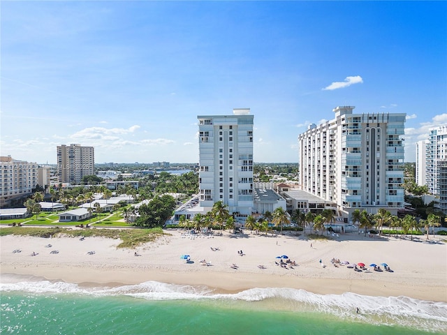 bird's eye view with a water view and a beach view