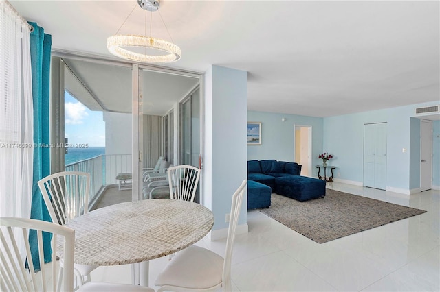 tiled dining space featuring a water view