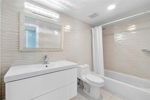 full bathroom with tile patterned floors, toilet, shower / tub combo, tile walls, and vanity