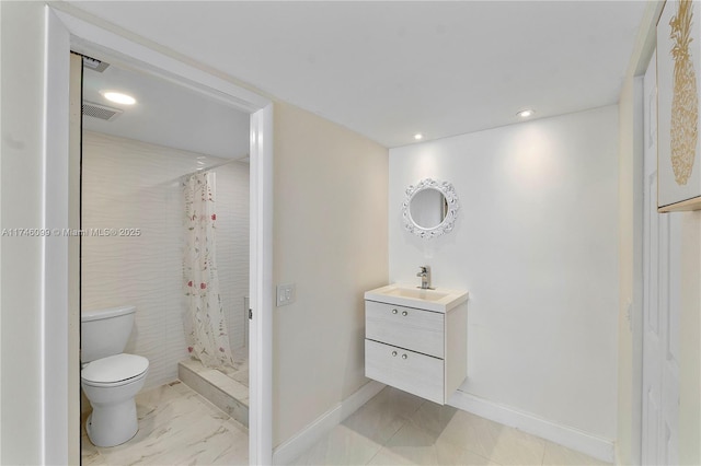 bathroom featuring vanity, toilet, and a shower with shower curtain