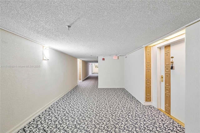 hall with carpet and a textured ceiling