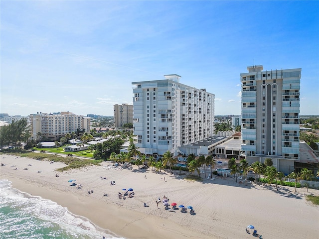 drone / aerial view with a water view and a beach view