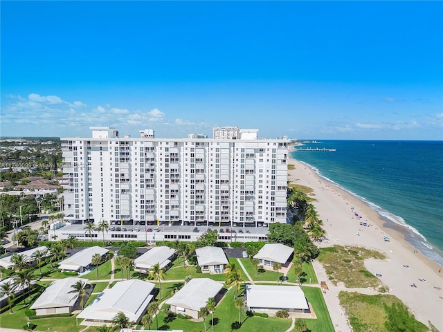 drone / aerial view with a beach view and a water view