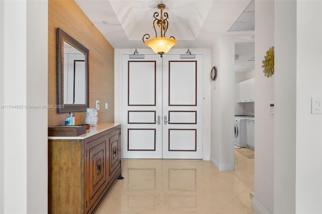 bathroom featuring vanity, washer and clothes dryer, and toilet