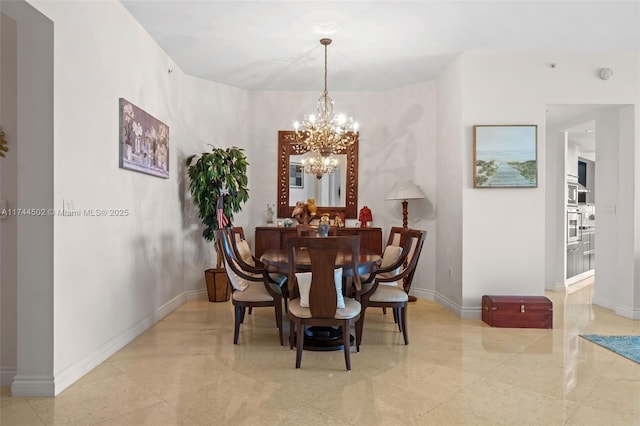 dining area featuring an inviting chandelier