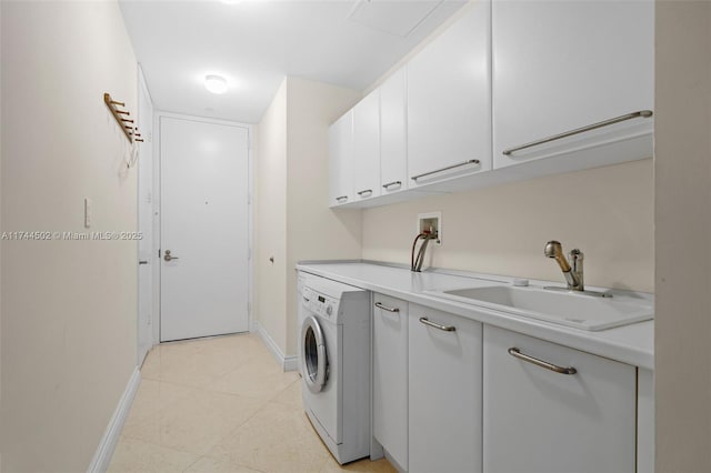 laundry area with cabinets, washer / clothes dryer, and sink