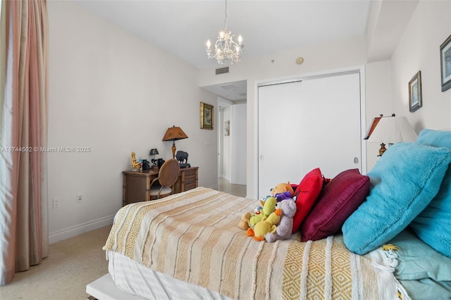 carpeted bedroom featuring a notable chandelier and a closet