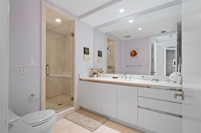 bathroom featuring walk in shower, vanity, toilet, and tile patterned flooring