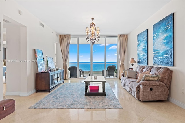 living room with expansive windows, a water view, and a chandelier