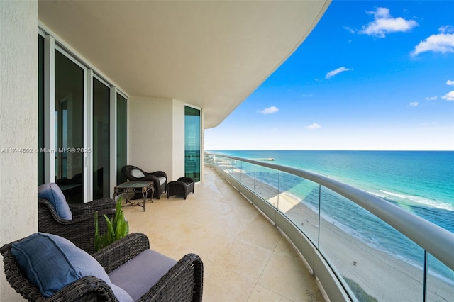 balcony with a view of the beach and a water view