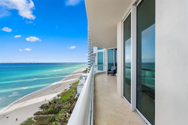 balcony with a beach view and a water view