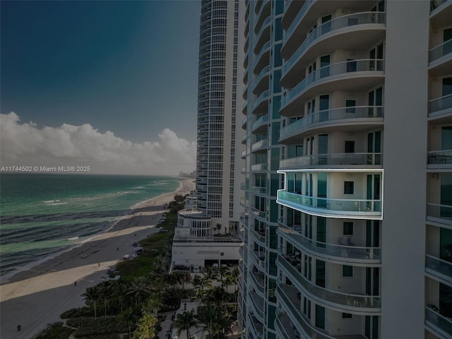 view of building exterior with a view of the beach and a water view