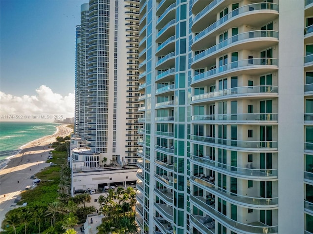 view of building exterior with a view of the beach and a water view