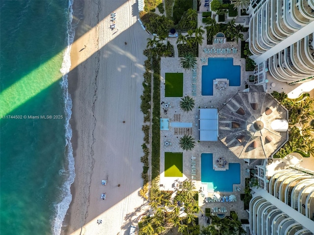 bird's eye view featuring a beach view and a water view